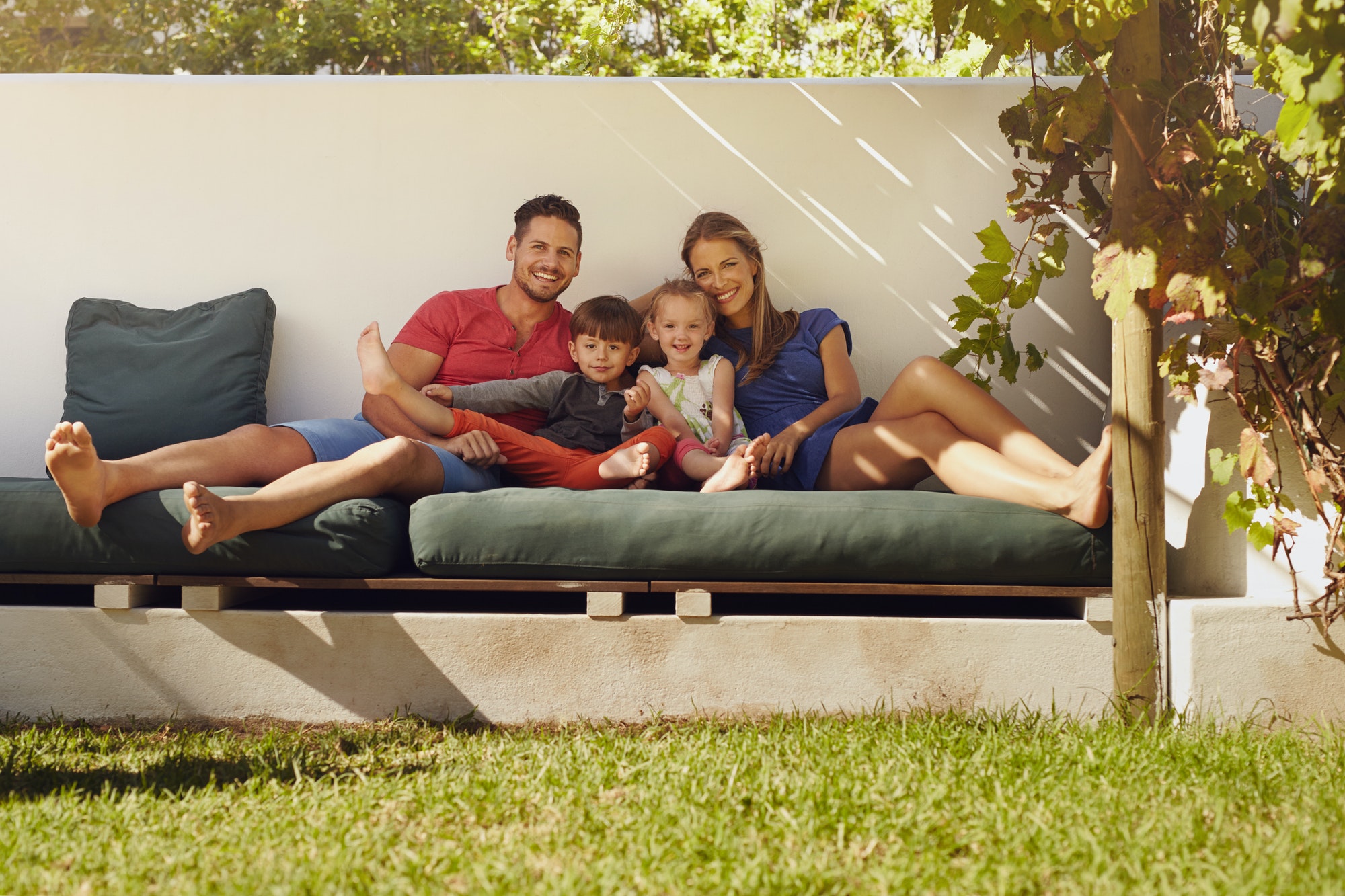 Happy young family sitting on patio